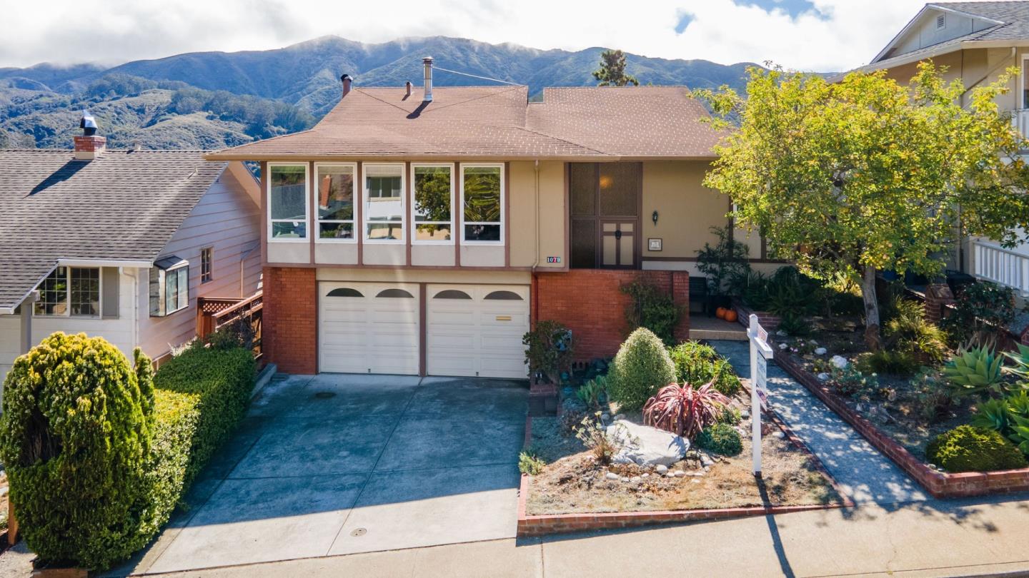 1079 Park Pacifica Avenue Pacifica, CA 94044 - Photo 4 of 43 a front view of a house with a garden