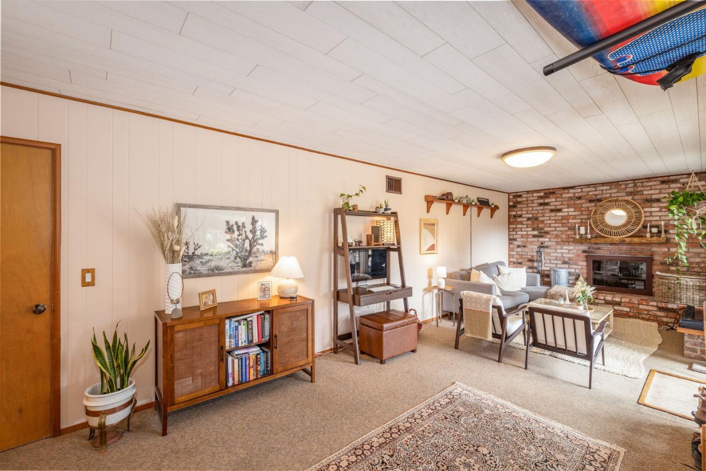 1079 Park Pacifica Avenue Pacifica, CA 94044 - Photo 31 of 43 a living room with furniture a fireplace and a large window