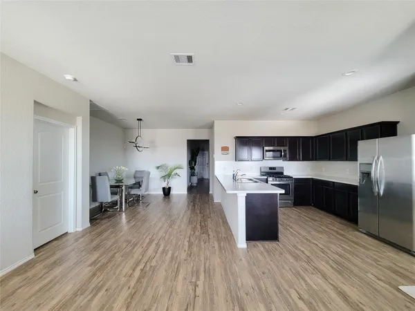 a living room with a couch and a wooden floor