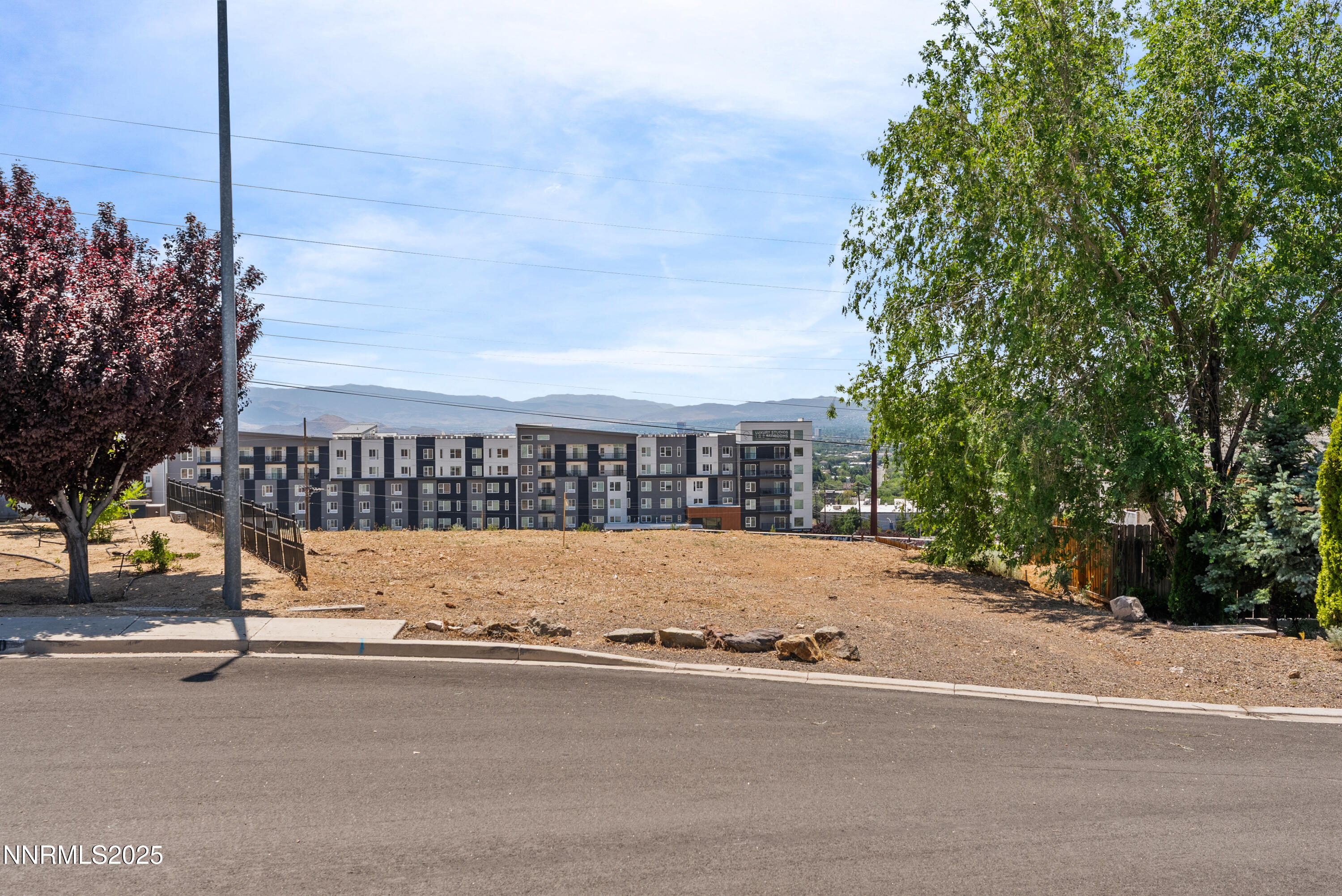 970 Demos Court Reno, NV 89512 - Photo 1 of 26 a view of a street with a building in the background