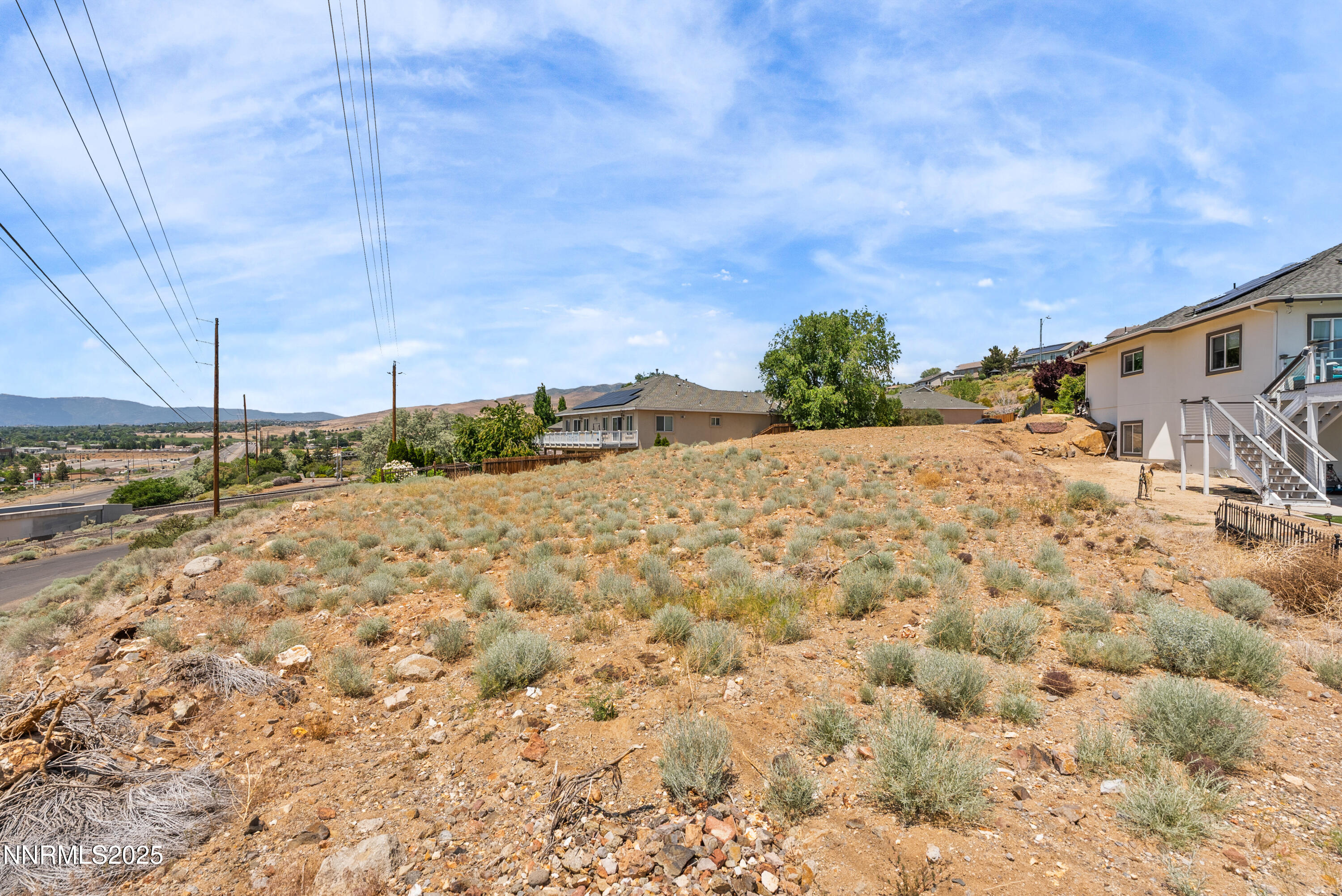 970 Demos Court Reno, NV 89512 - Photo 8 of 26 a view of a dry yard with wooden fence
