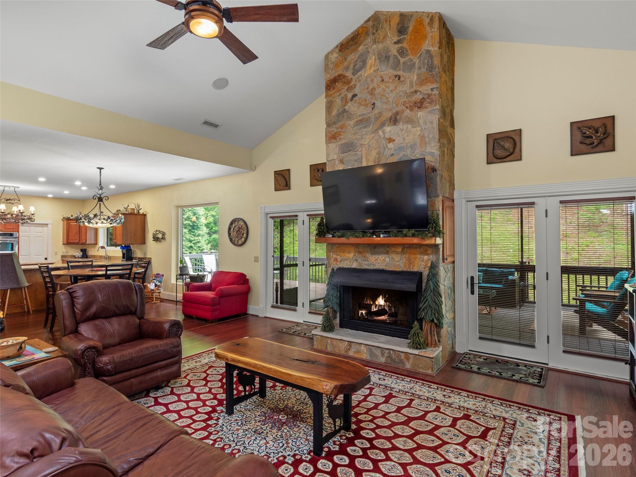 79 Ward Road Maggie Valley, NC 28751 - Photo 11 of 48 a living room with furniture a flat screen tv and a fireplace
