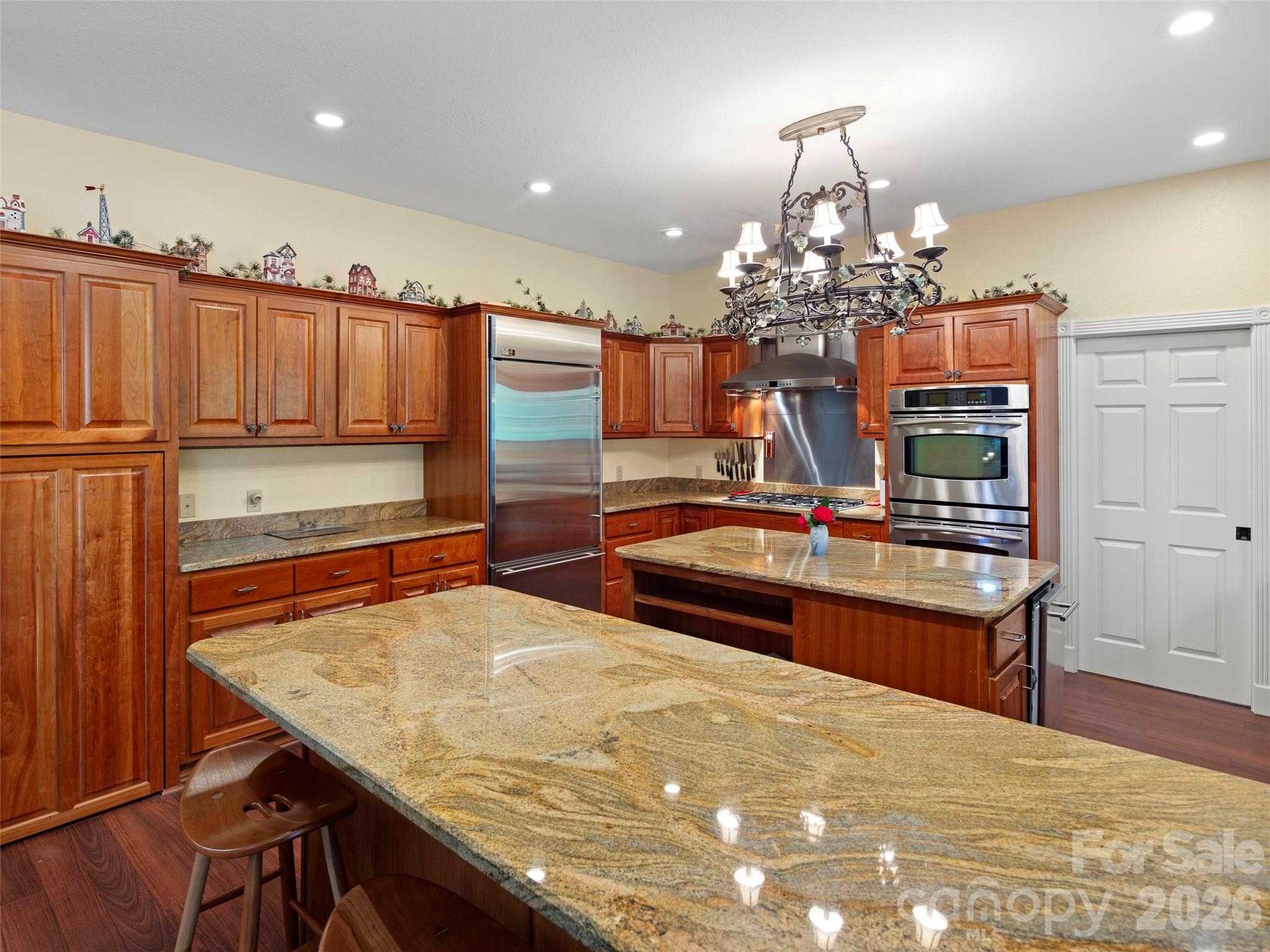 79 Ward Road Maggie Valley, NC 28751 - Photo 16 of 48 a room with kitchen island a chandelier and wooden cabinets
