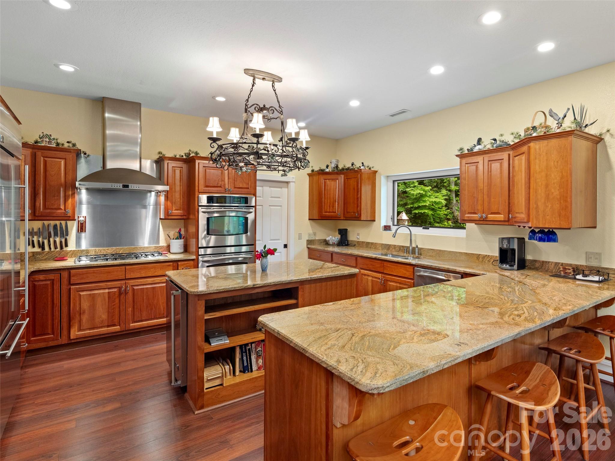 79 Ward Road Maggie Valley, NC 28751 - Photo 17 of 48 a kitchen with stainless steel appliances granite countertop a sink counter space and wooden floor