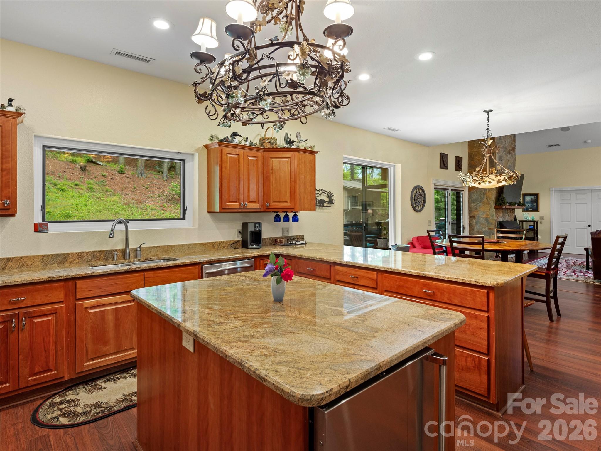 79 Ward Road Maggie Valley, NC 28751 - Photo 18 of 48 a kitchen with stainless steel appliances granite countertop a sink a table and chairs