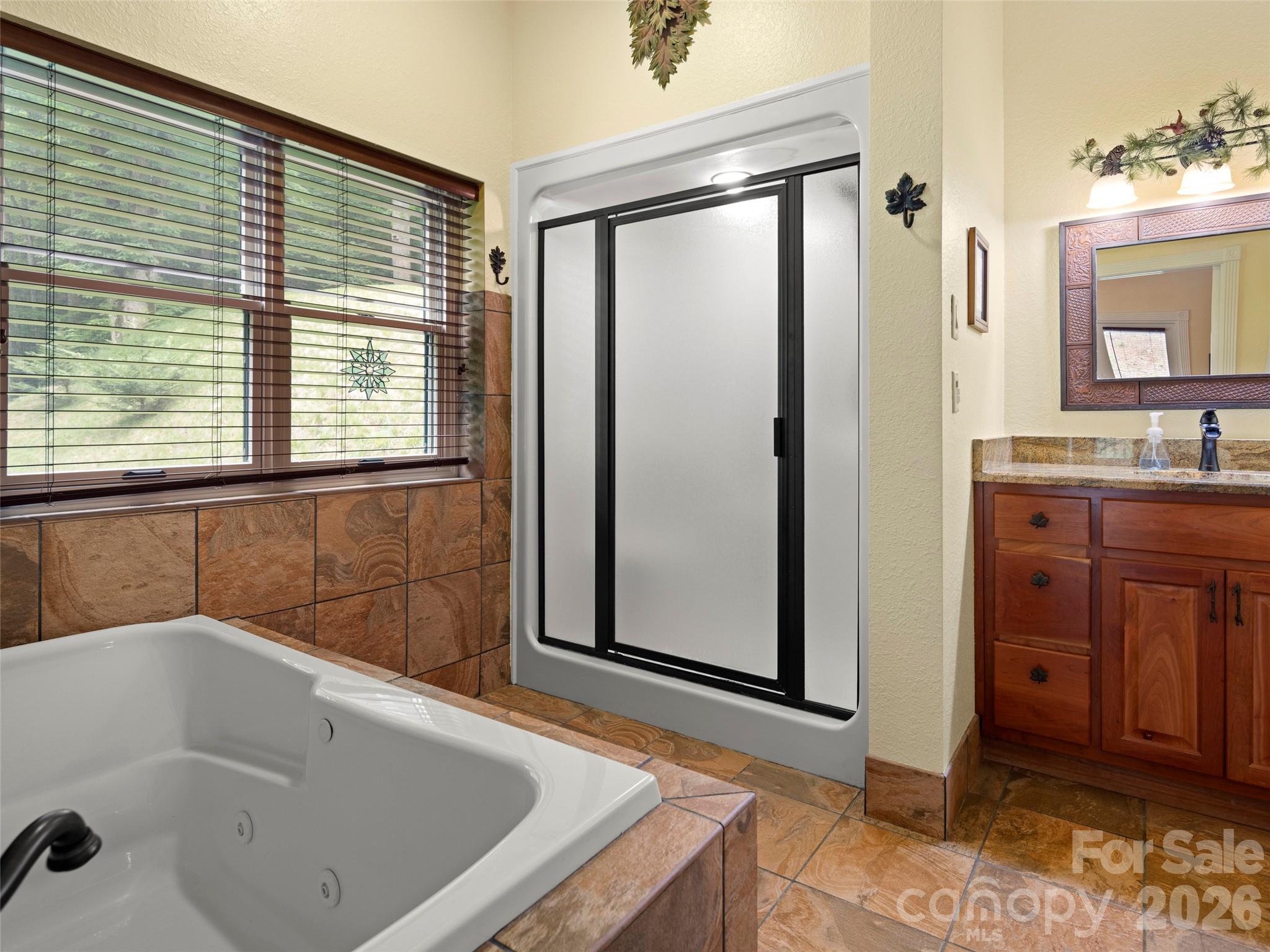 79 Ward Road Maggie Valley, NC 28751 - Photo 24 of 48 a bathroom with a tub sink and mirror
