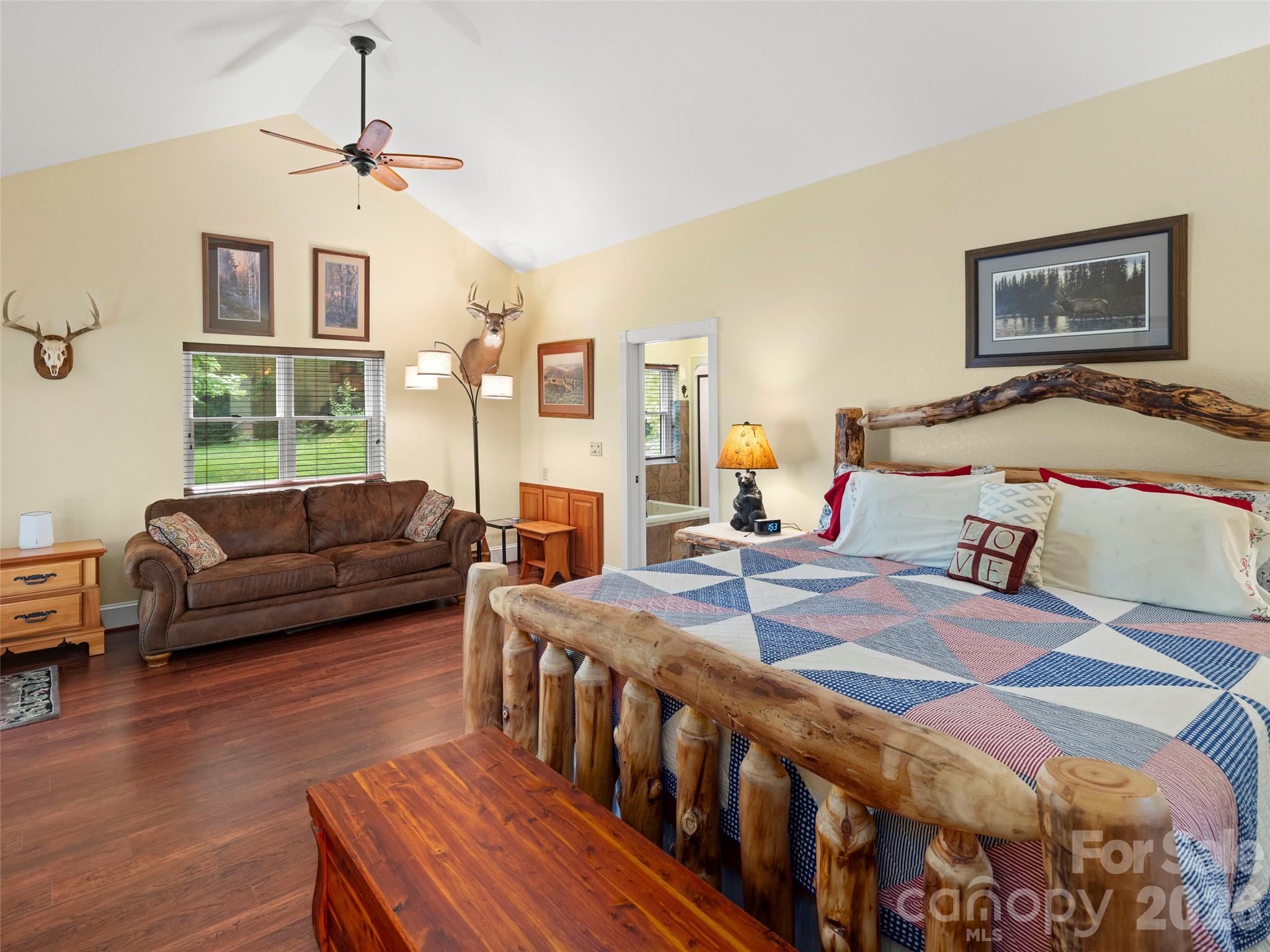 79 Ward Road Maggie Valley, NC 28751 - Photo 25 of 48 a bedroom with a bed a couch and a dresser