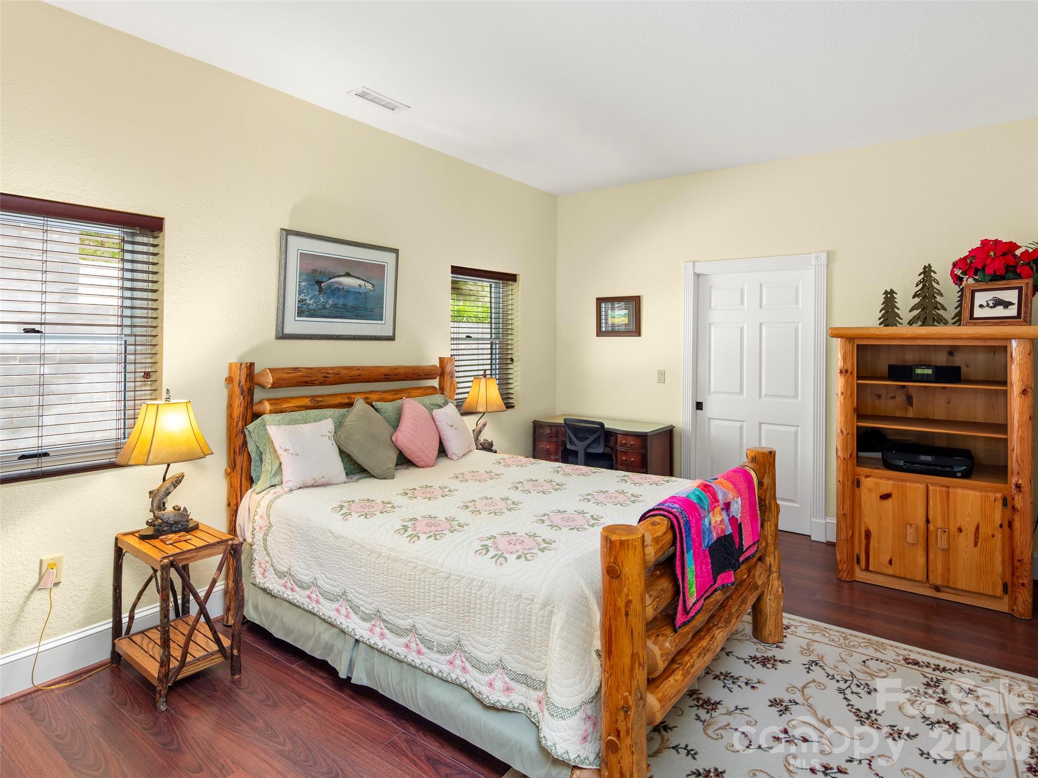 79 Ward Road Maggie Valley, NC 28751 - Photo 28 of 48 a bedroom with a bed and wooden floor
