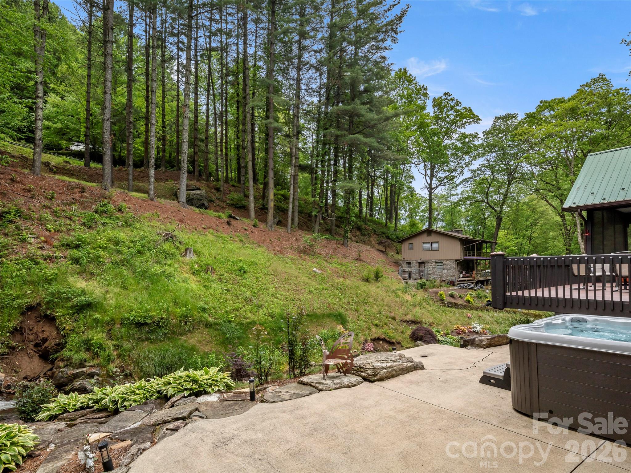 79 Ward Road Maggie Valley, NC 28751 - Photo 40 of 48 a backyard of a house with table and chairs