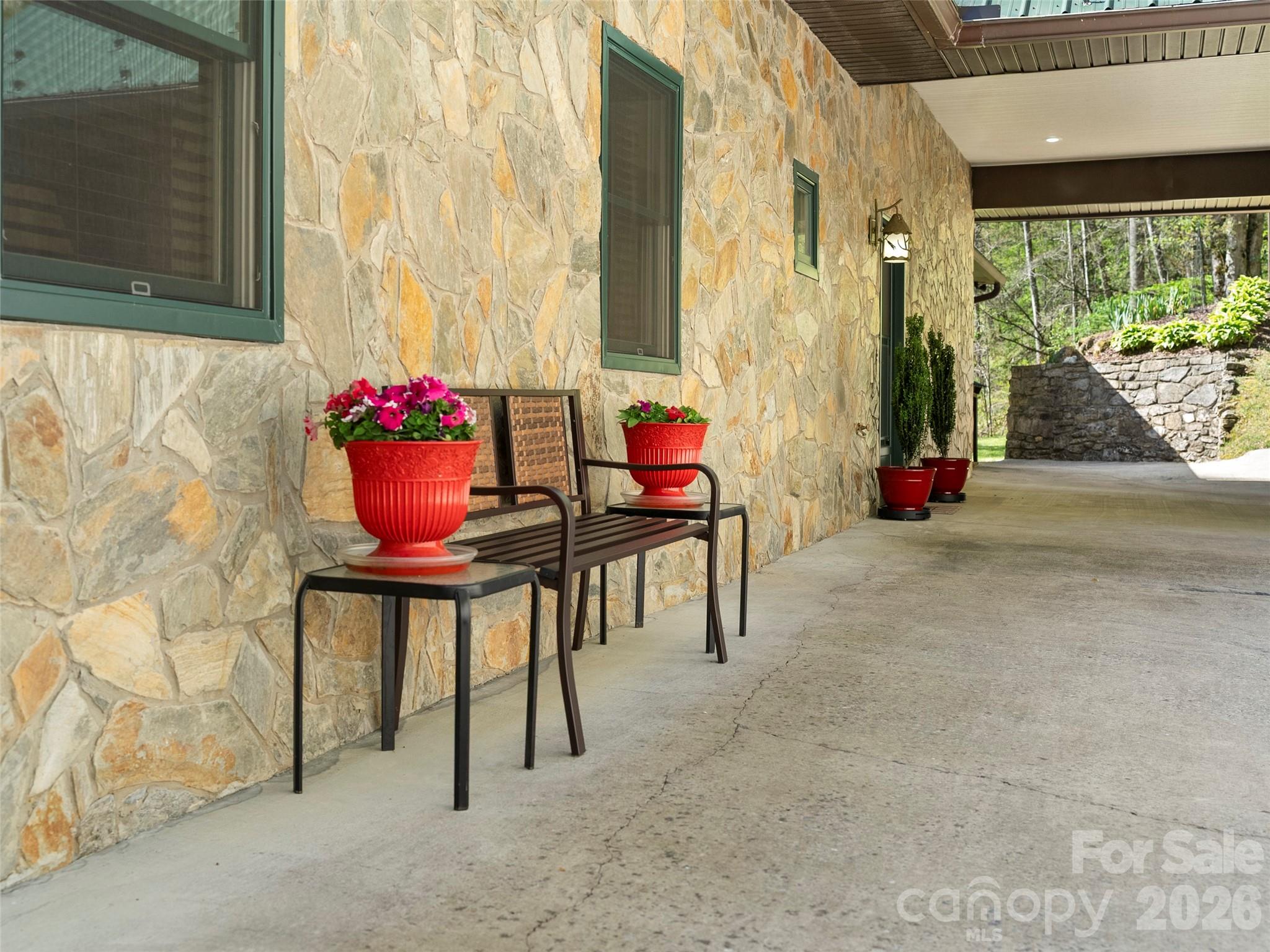 79 Ward Road Maggie Valley, NC 28751 - Photo 4 of 48 a view of an outdoor sitting area with brick walls