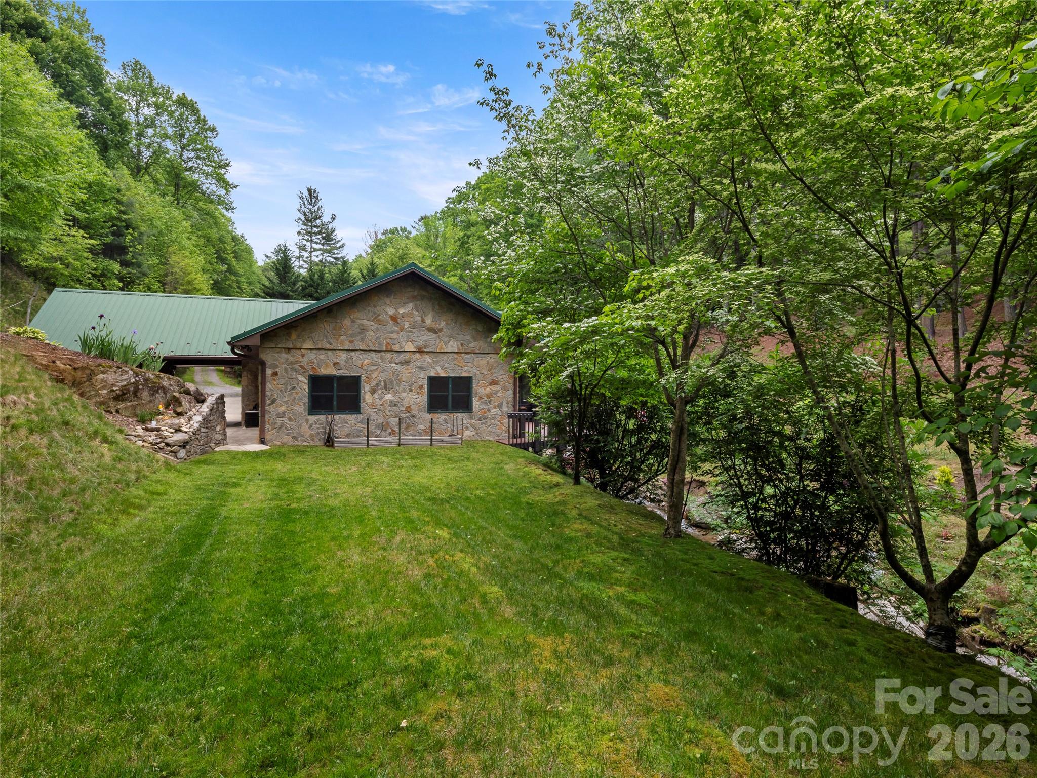 79 Ward Road Maggie Valley, NC 28751 - Photo 44 of 48 a front view of a house with garden