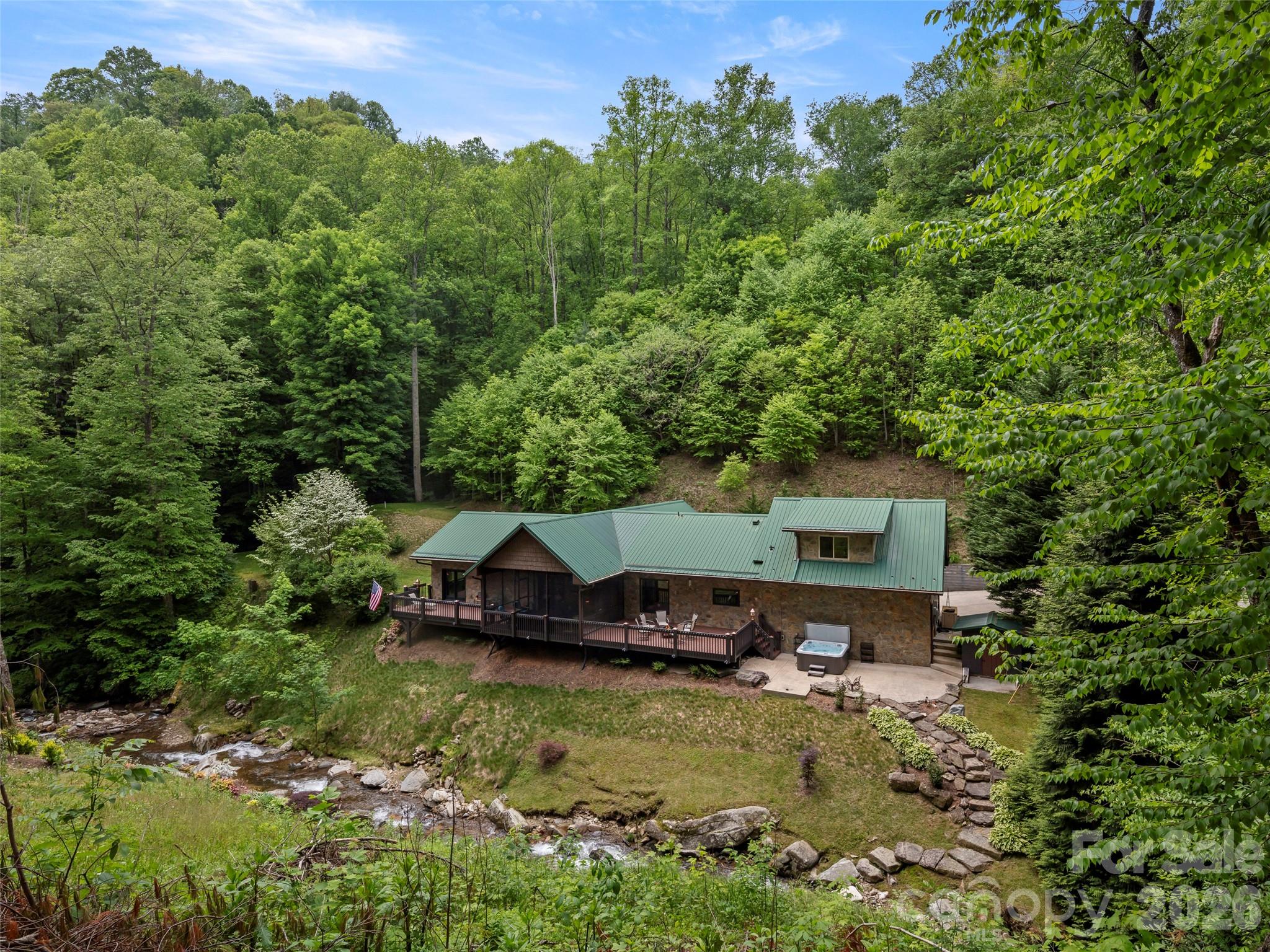 79 Ward Road Maggie Valley, NC 28751 - Photo 45 of 48 an aerial view of a house with swimming pool a yard and lake view
