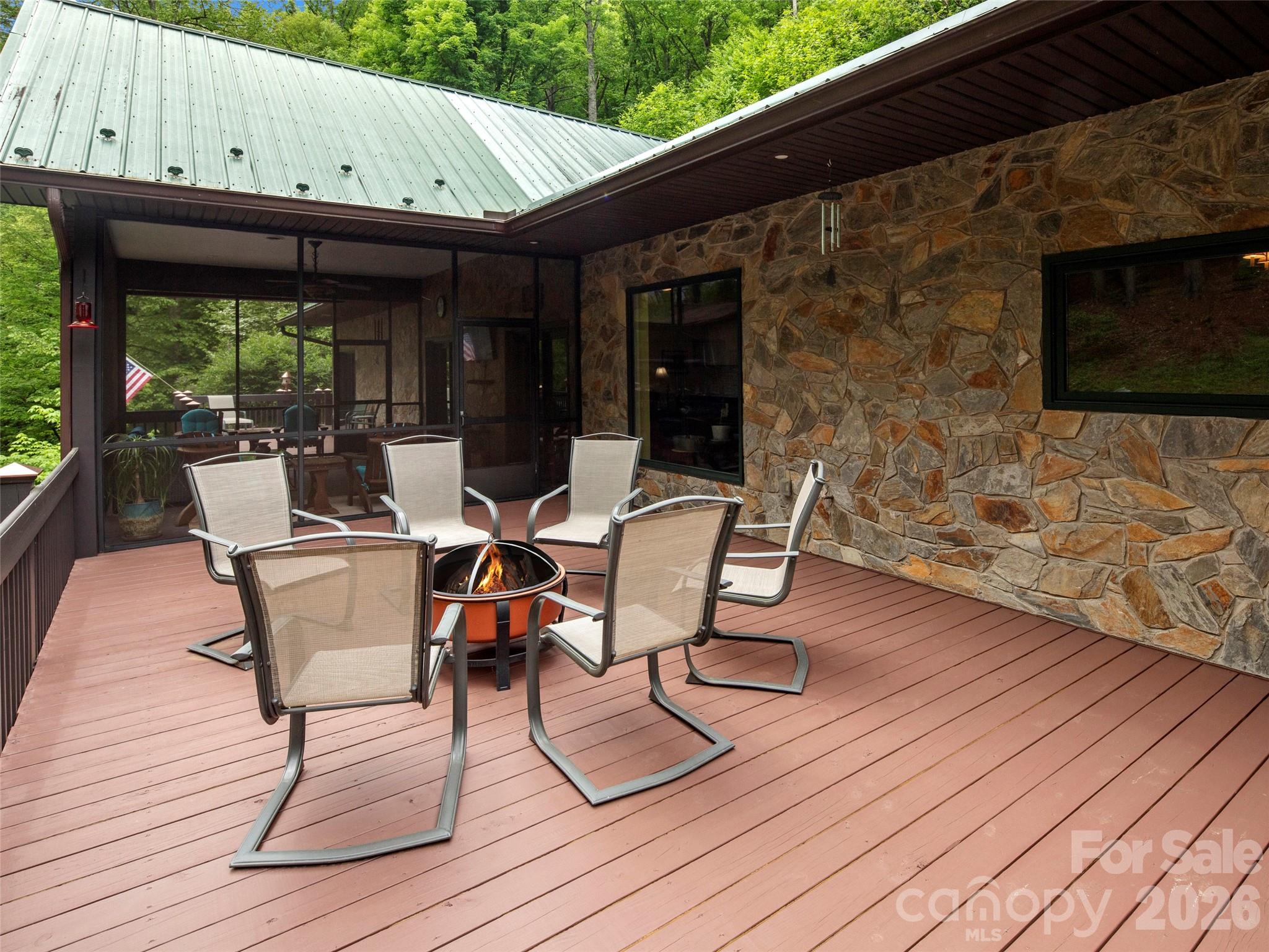 79 Ward Road Maggie Valley, NC 28751 - Photo 8 of 48 a view of a patio with table and chairs with wooden floor and plants