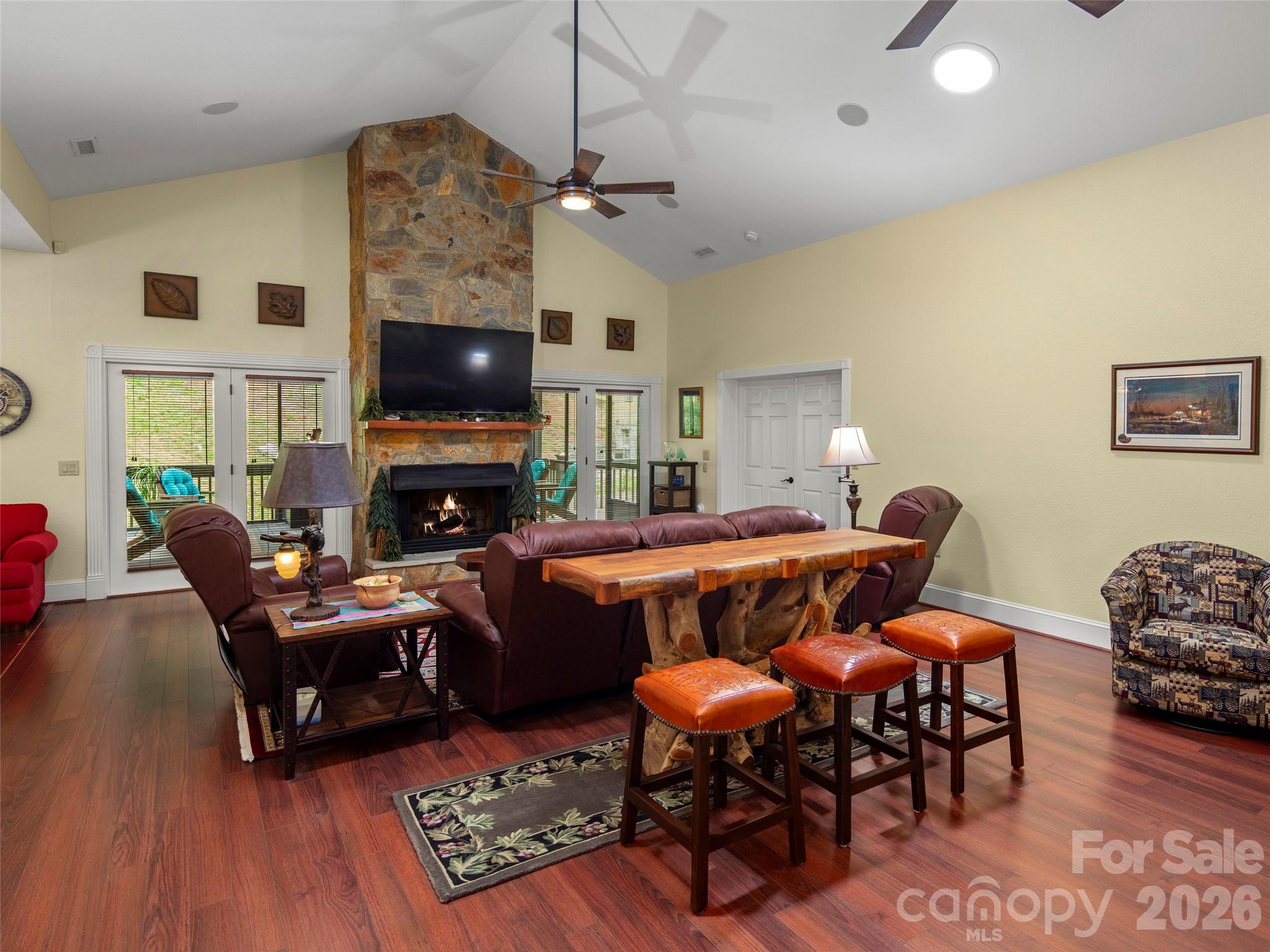 79 Ward Road Maggie Valley, NC 28751 - Photo 9 of 48 a living room with furniture a flat screen tv and a fireplace