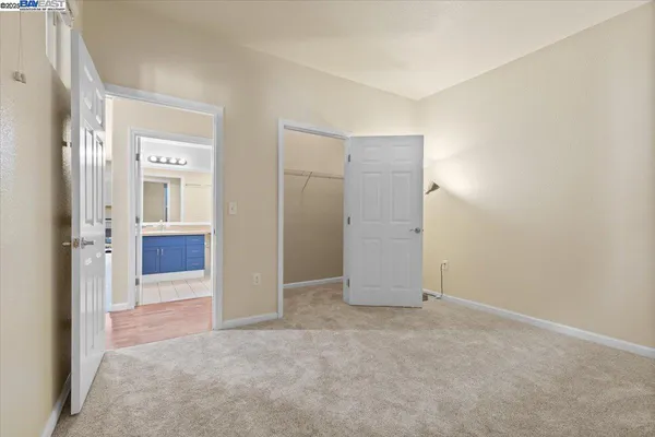 an empty room with windows and bathroom