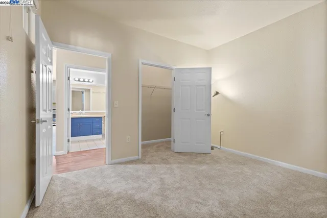 an empty room with windows and bathroom