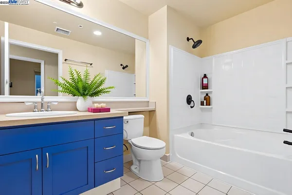 a bathroom with a bathtub shower sink and toilet