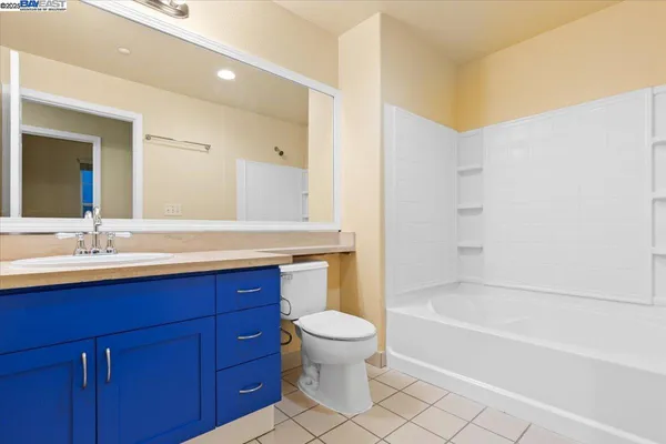 a bathroom with a sink a toilet and a large mirror