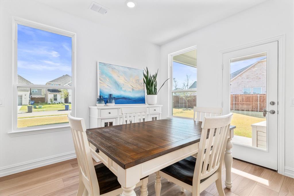 4001 Maida Road McKinney, TX 75071 - Photo 14 of 36 a dining room with wooden floor and large window