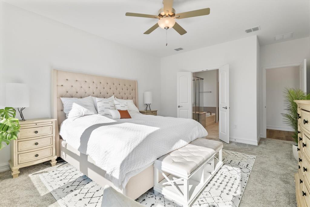 4001 Maida Road McKinney, TX 75071 - Photo 19 of 36 a bedroom with a bed and a chandelier