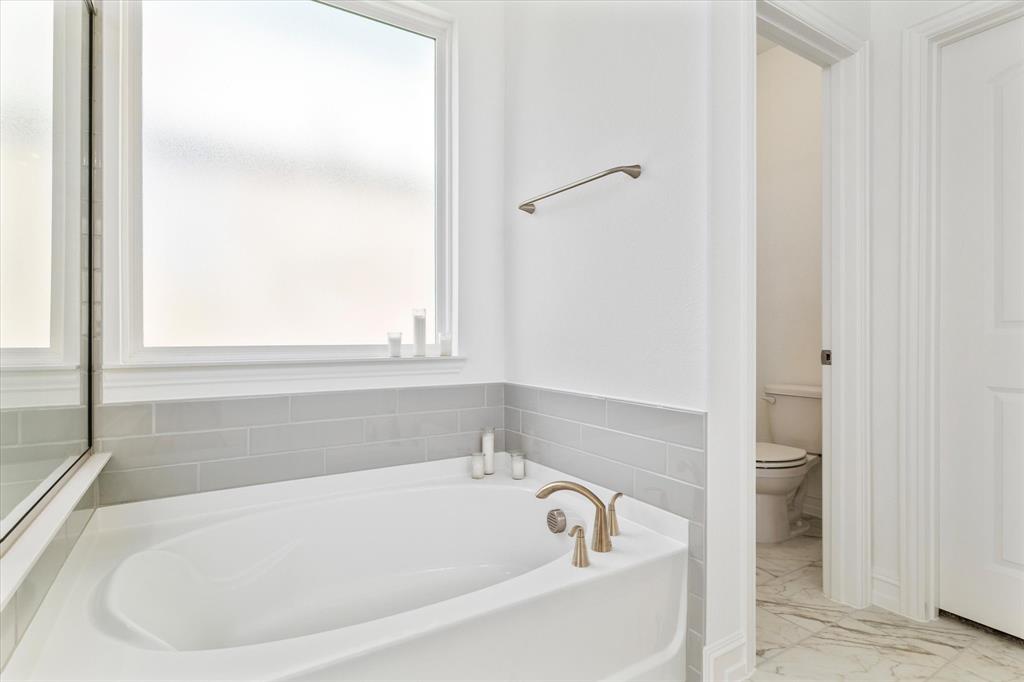 4001 Maida Road McKinney, TX 75071 - Photo 23 of 36 a white bath tub sitting next to a window