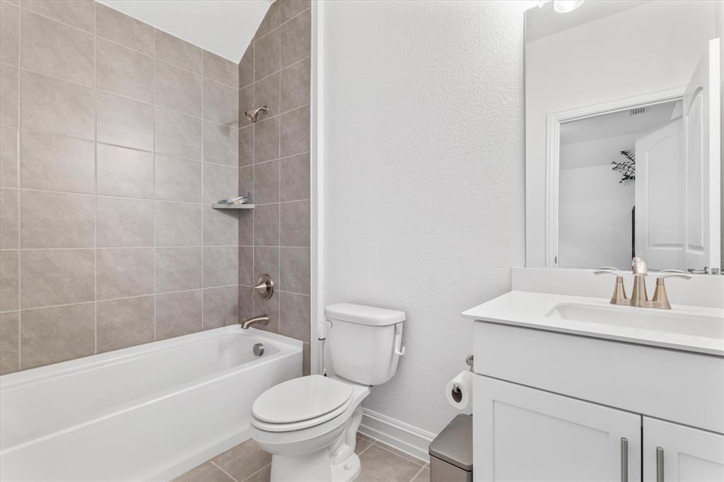 4001 Maida Road McKinney, TX 75071 - Photo 27 of 36 a bathroom with a sink toilet vanity and shower