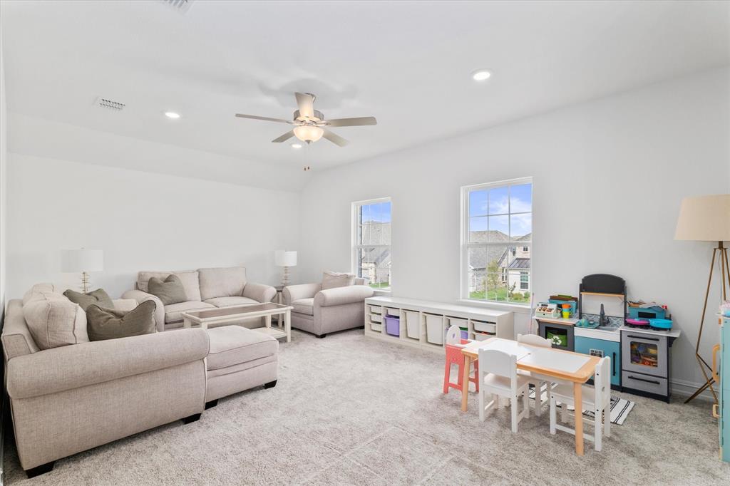 4001 Maida Road McKinney, TX 75071 - Photo 28 of 36 a living room with furniture and a book shelf