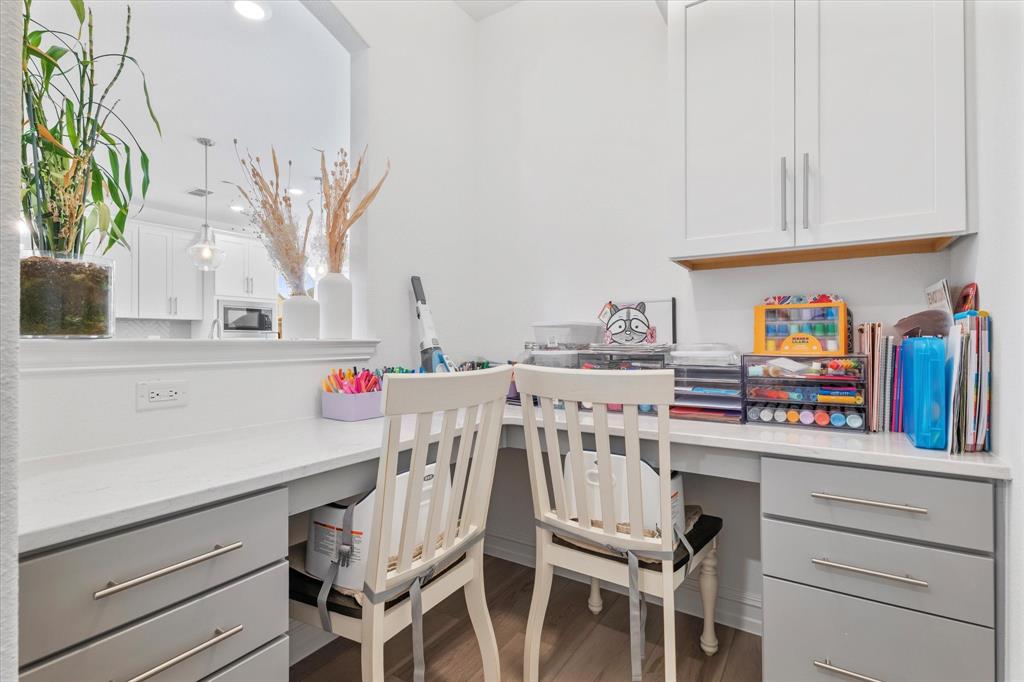 4001 Maida Road McKinney, TX 75071 - Photo 9 of 36 a white kitchen with a stove a sink cabinets and a dining table