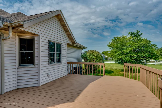 a view of a house with backyard and deck