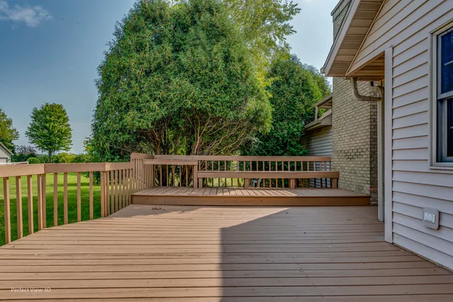 a balcony with wooden floor and fence