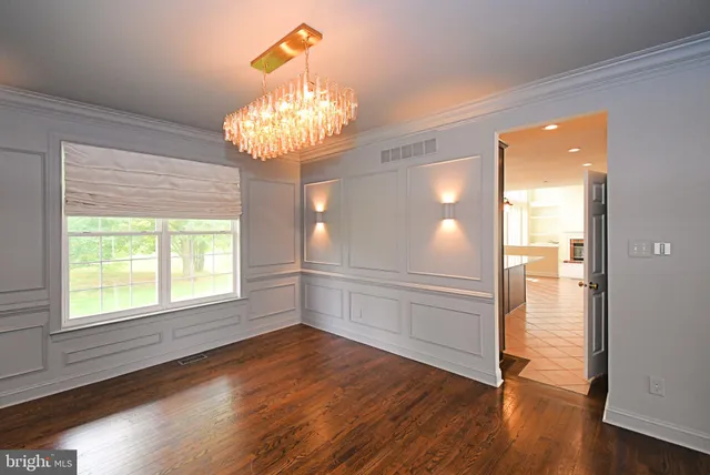 a kitchen with stainless steel appliances granite countertop a sink a stove and a wooden floors
