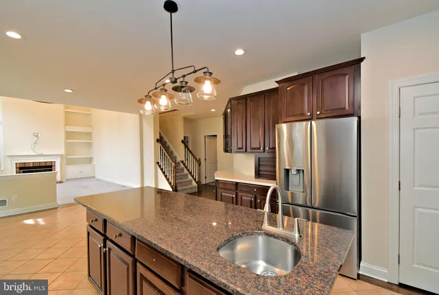 a view of an empty room with a fireplace and a window