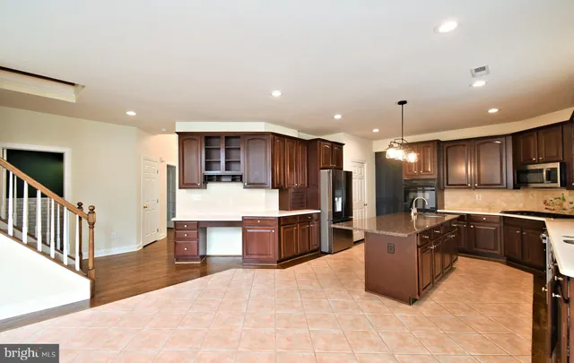 a view of a livingroom with wooden floor and a ceiling fan