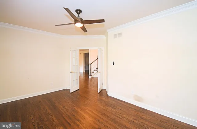 an empty room with a empty space and a ceiling fan