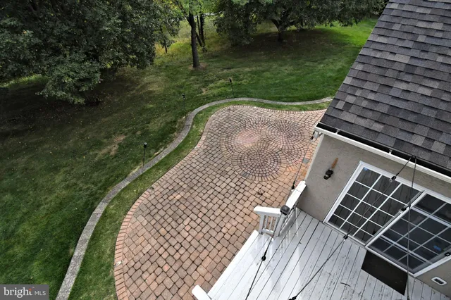 a view of a white house with a yard and sitting area