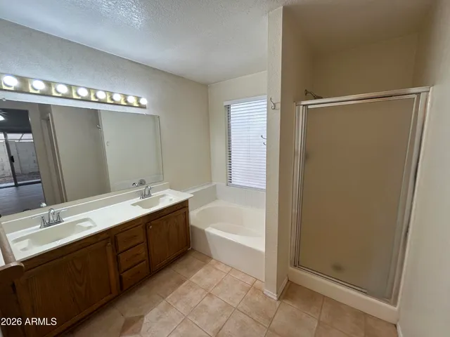 a bathroom with a tub sink and mirror