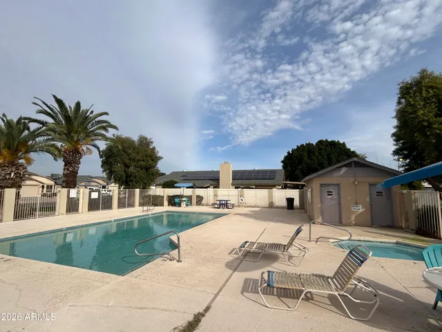 a view of a backyard with a patio and swimming pool