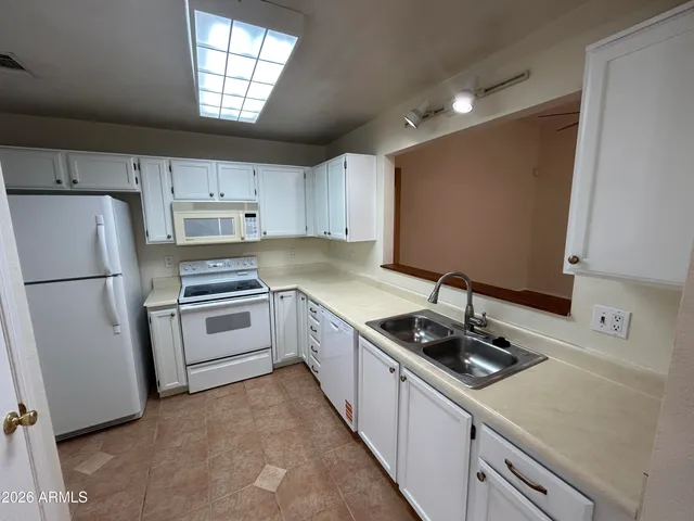 a kitchen with a refrigerator stove and sink
