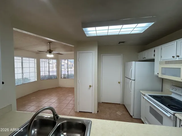 a kitchen with a sink a refrigerator and window