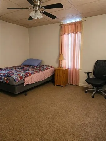 a bedroom with a bed and a chair
