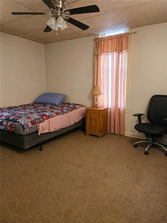 2024 7th Avenue Beaver Falls, PA 15010 - Photo 3 of 8 a bedroom with a bed and a chair