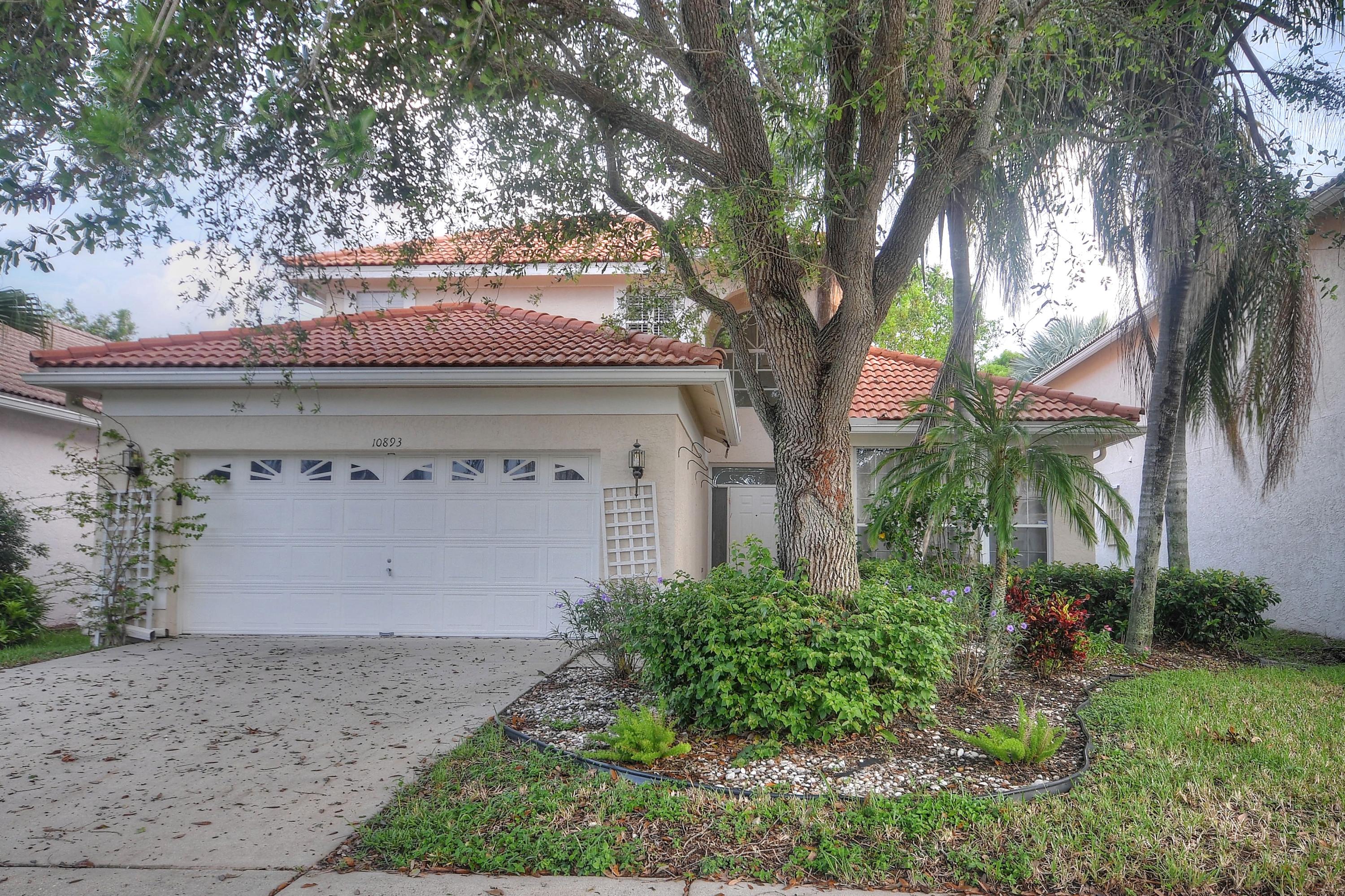 10893 Old Bridgeport Lane Boca Raton, FL 33498 - Photo 1 of 1 a front view of a house with a yard and garage