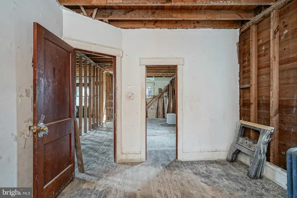 a view of a porch with a table and chairs