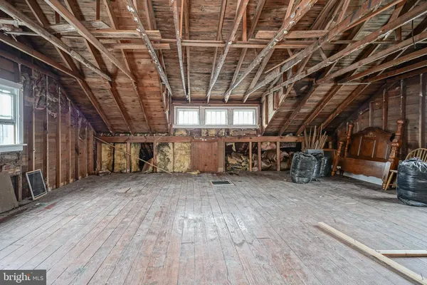 a view of an empty room with wooden ceiling