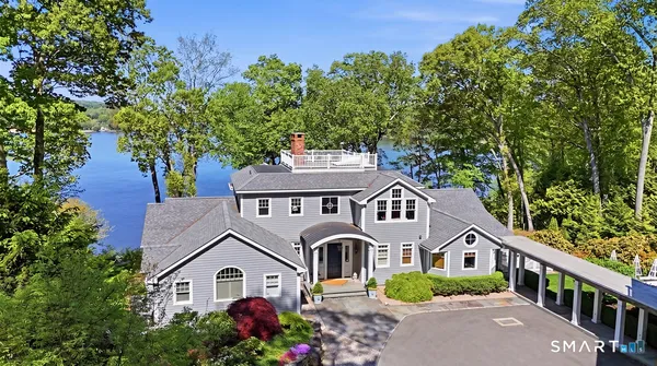 an aerial view of a house with a yard and potted plants
