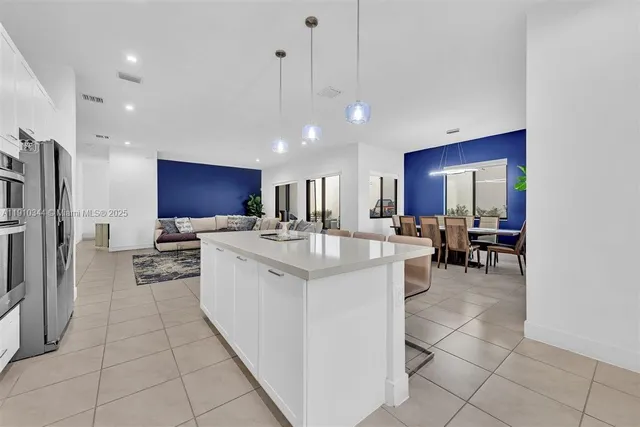 a large kitchen with a large counter top appliances and cabinets