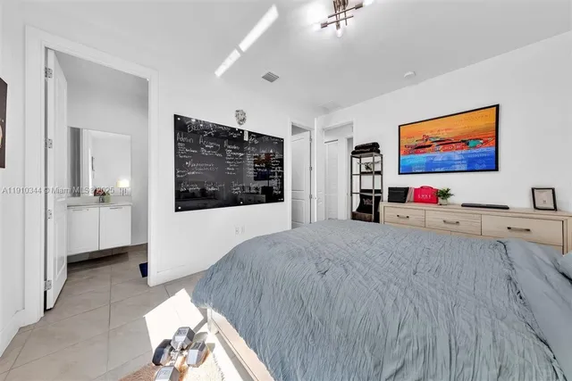a bedroom with furniture window and glass door