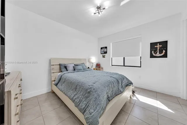 a spacious bedroom with a bed and a couch