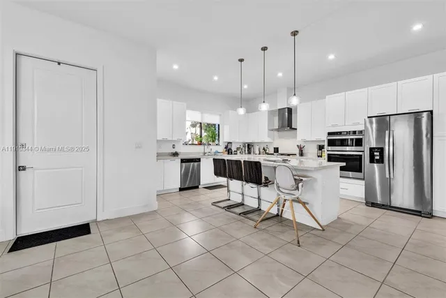 a kitchen with stainless steel appliances a refrigerator sink and microwave