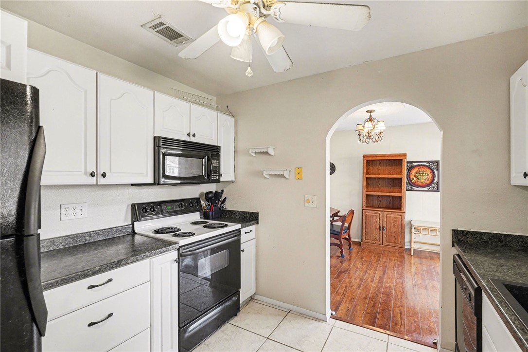 748 Cranbrook Avenue Northeast Palm Bay, FL 32905 - Photo 11 of 26 a kitchen with granite countertop a stove a sink and a microwave